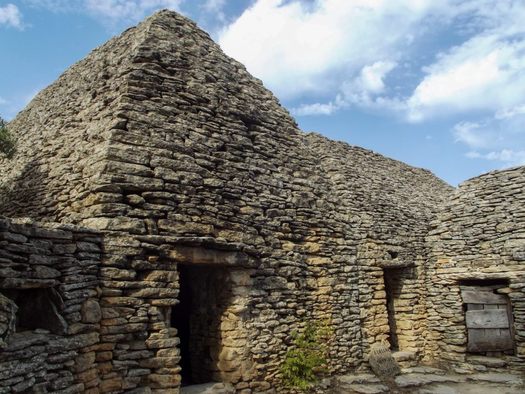 Preserved dry stone structures with doorways and windows in France.