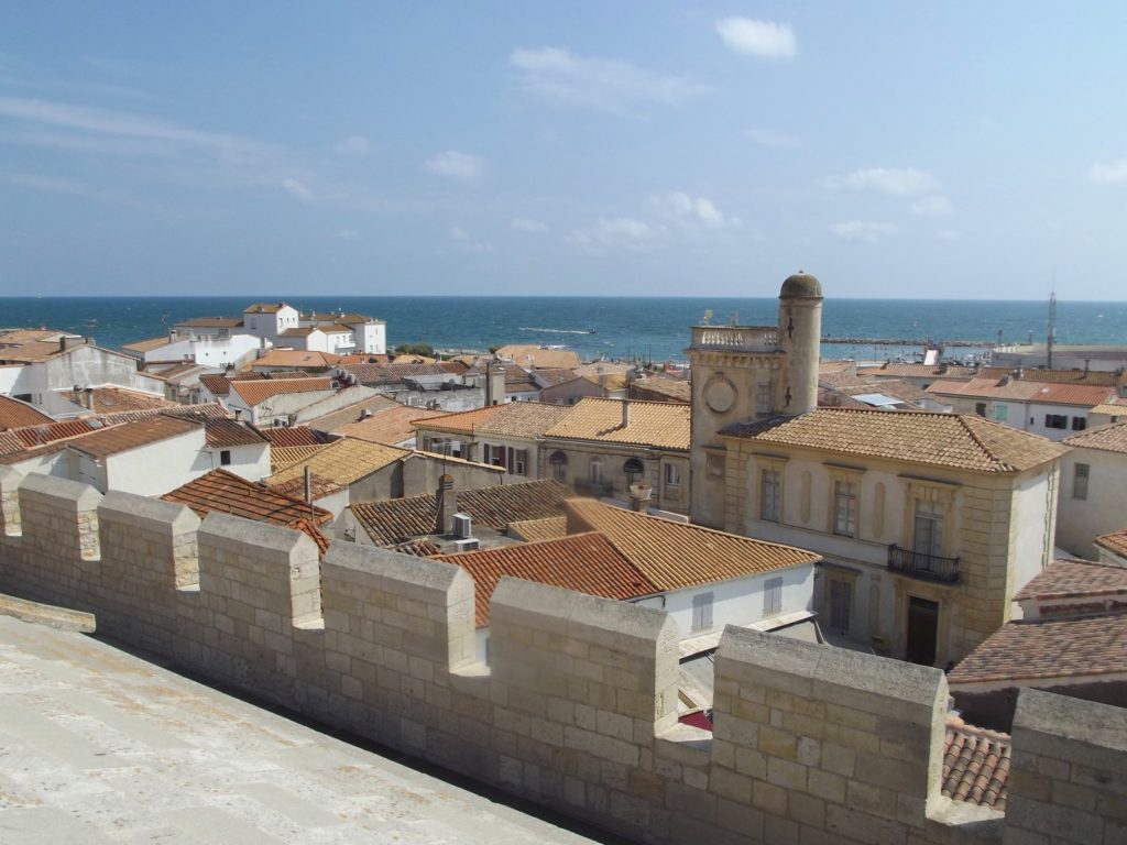 The orange rooftops of St Maries de la Mer stretch out to the sea.