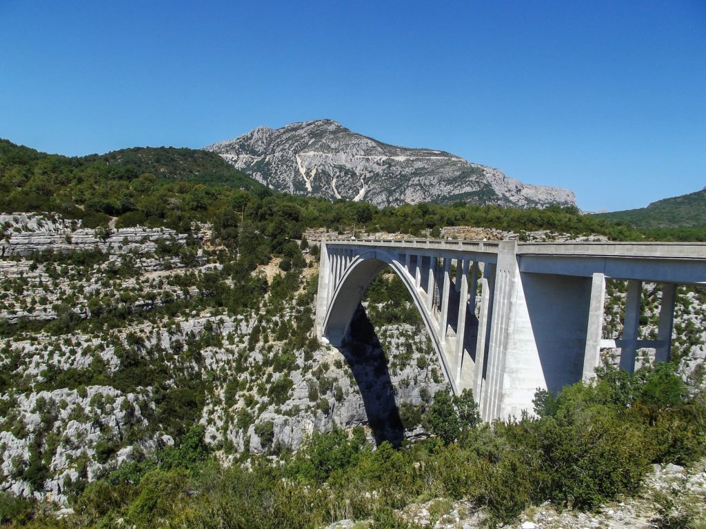 An impressive bridge crosses a rocky verge to the French mountains.