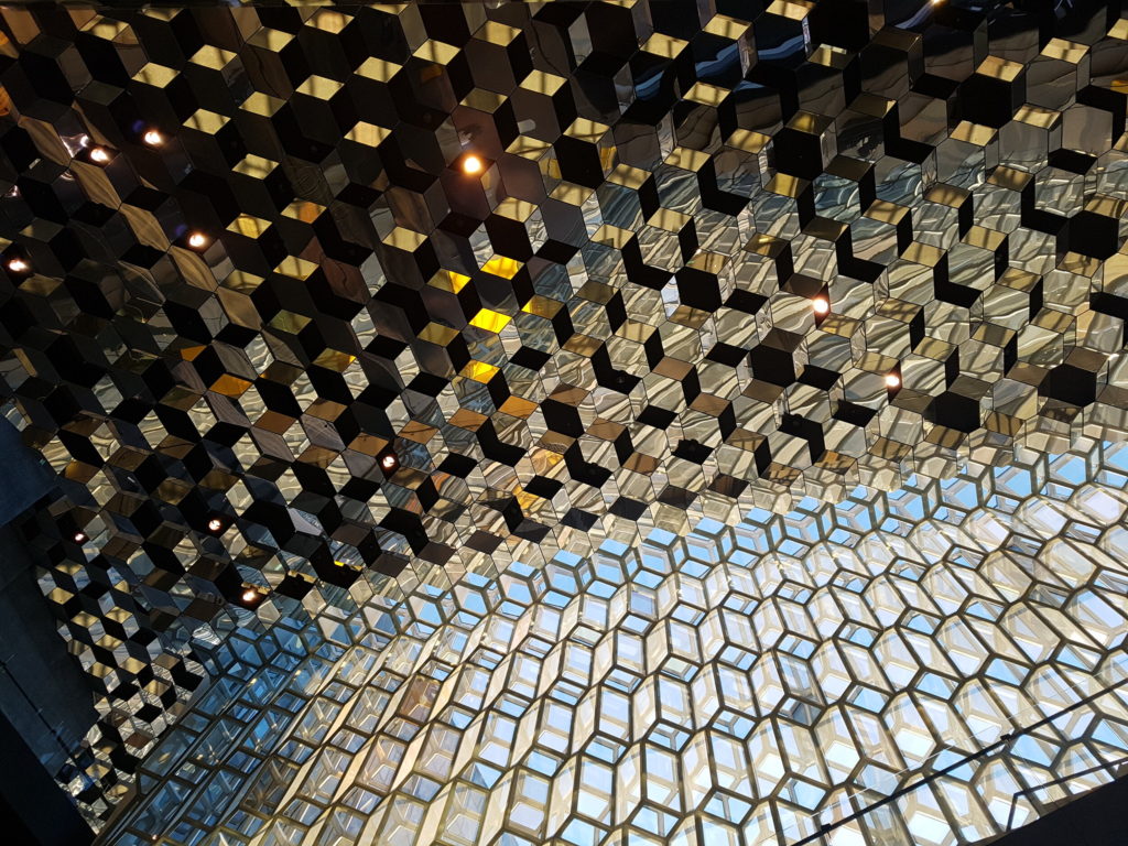 Sunlight shines off the geometric shapes of the Harpa Concert Hall ceiling.