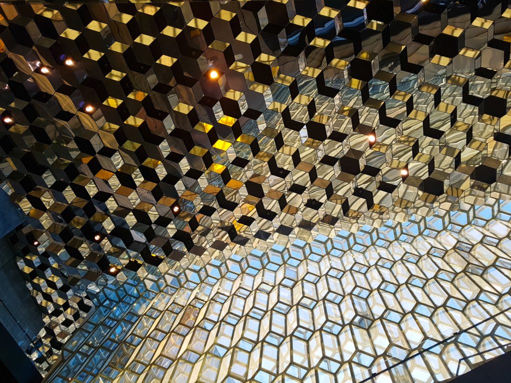 Sunlight shines off the geometric shapes of the Harpa Concert Hall ceiling.