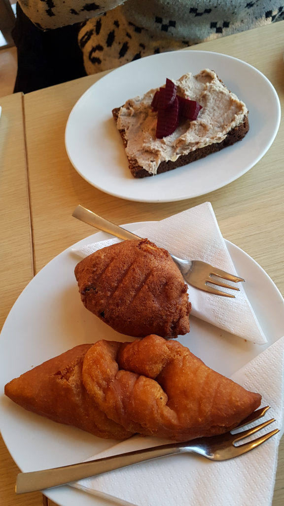 Golden pastries and a slice of rye bread with pate.