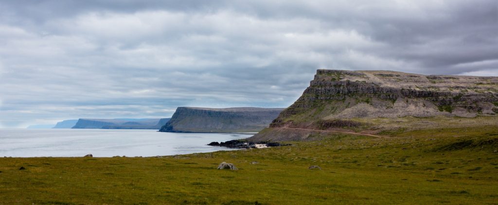The cliffs of Vestfirðir fade into the distance across the Icelandic coast.
