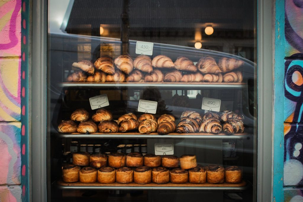 Golden pastries in the shop window of Brauð & Co.