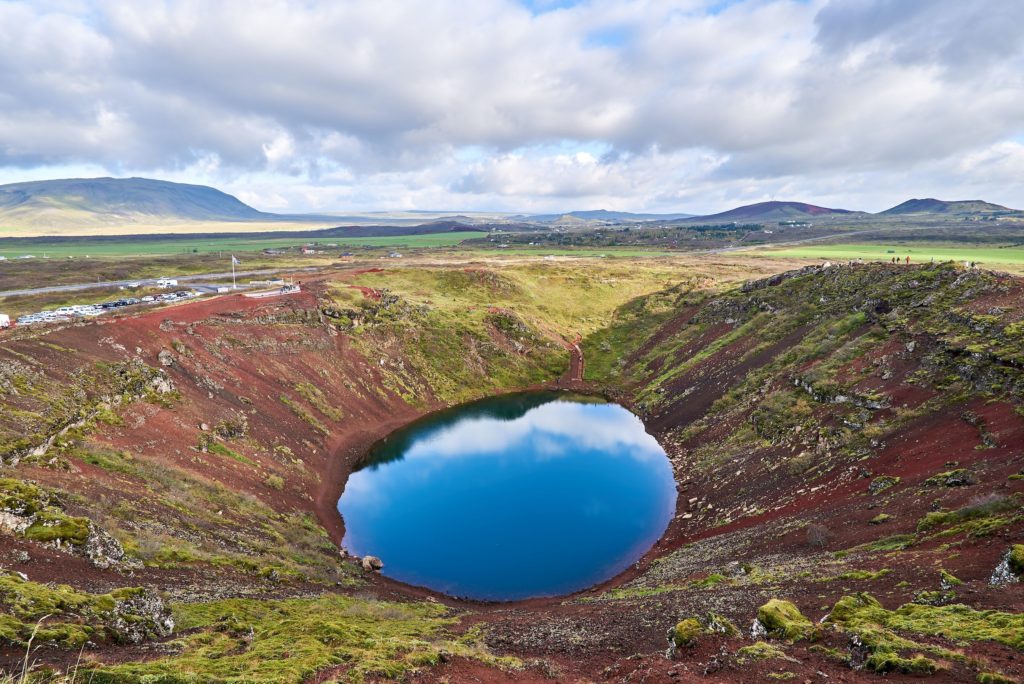 Looking down into Kerið Crater we can see clean blue water and rocky red earth.