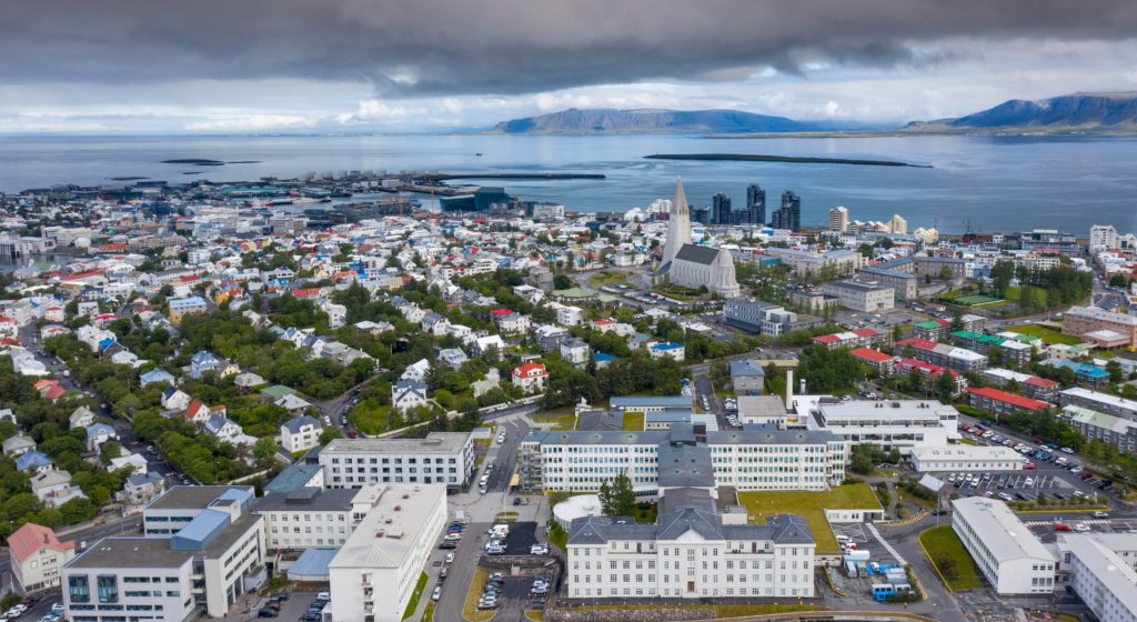 An aerial view of Reykjavik. Dark storm clouds can be seen overhead.