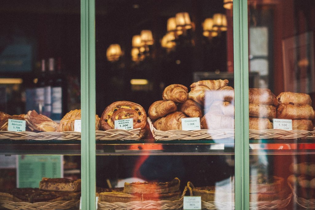 Fresh French pastries in a bakery window.