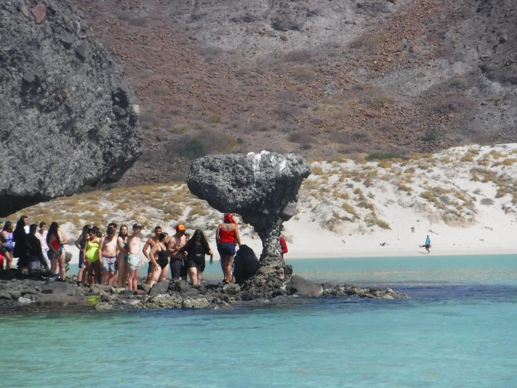 The famous mushroom rock (El Hongo) with a queue of tourists beside it.