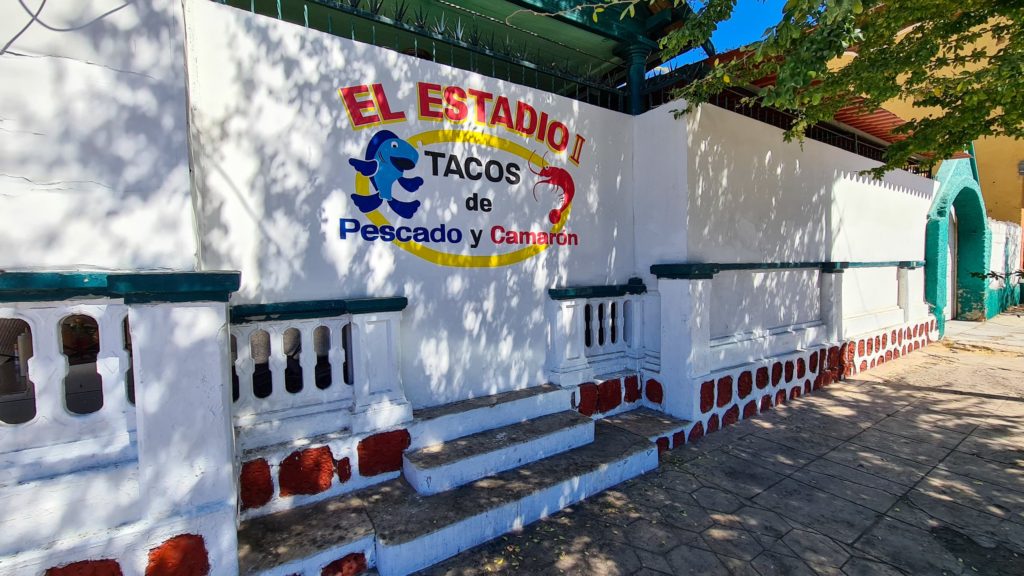 The outside wall of El Estadio is decorated with a colourful logo.