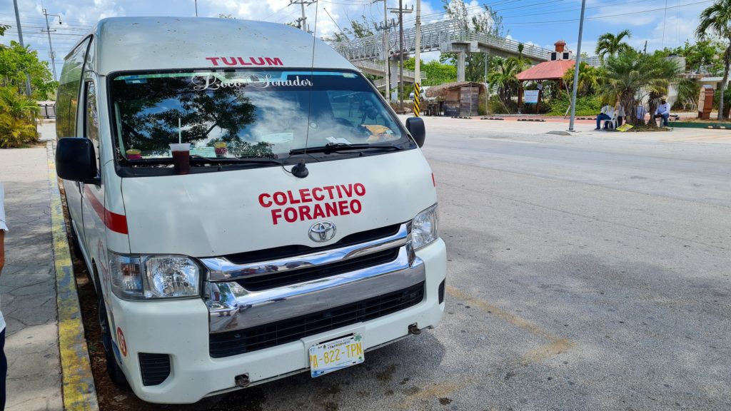 A colectivo mini-bus waits for passengers to board.