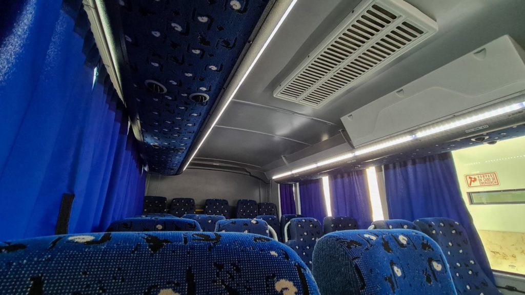 Inside a bus with blue seats