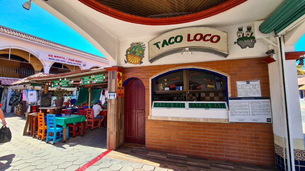 An outside salsa bar with a sign saying "Taco Loco"