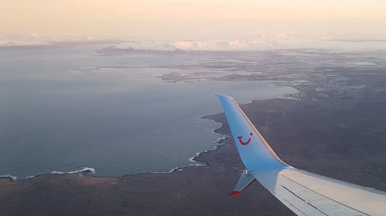 The smiling TUI logo can clearly be seen from the window of the plane.