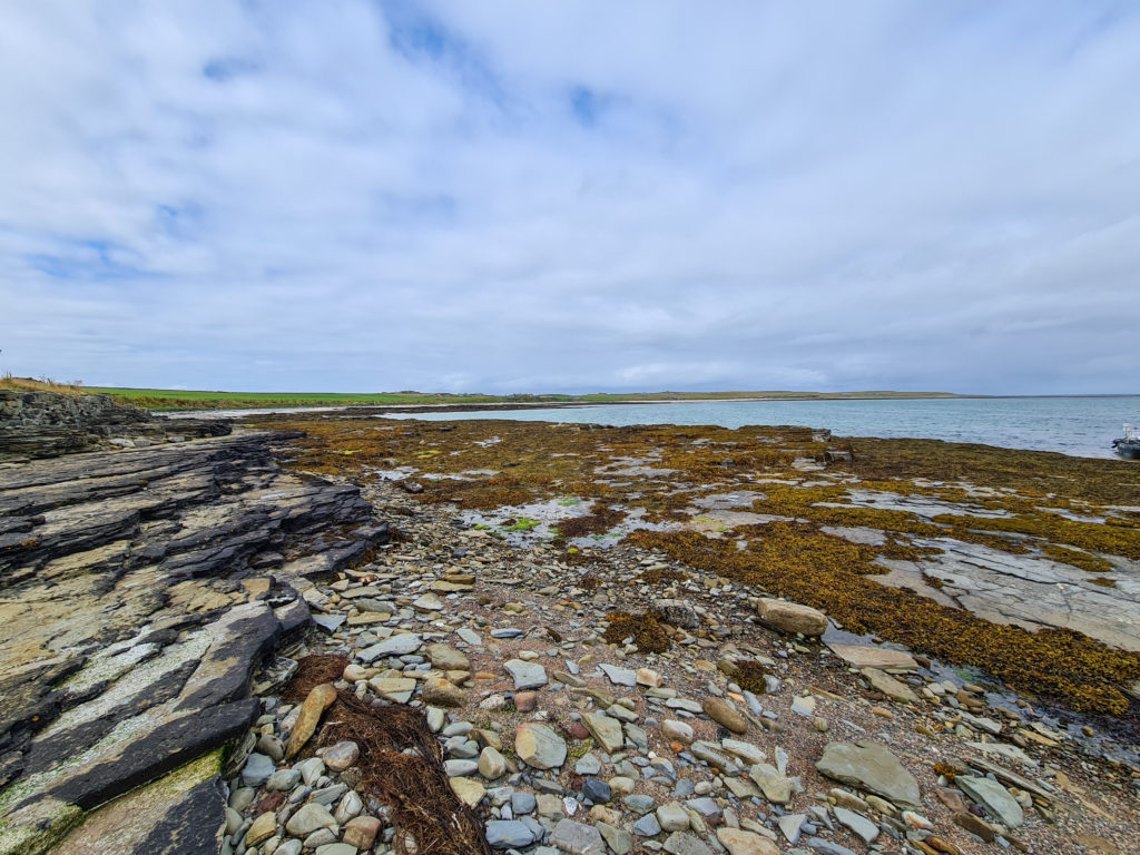 Sharp rocks stretch out to the sea.