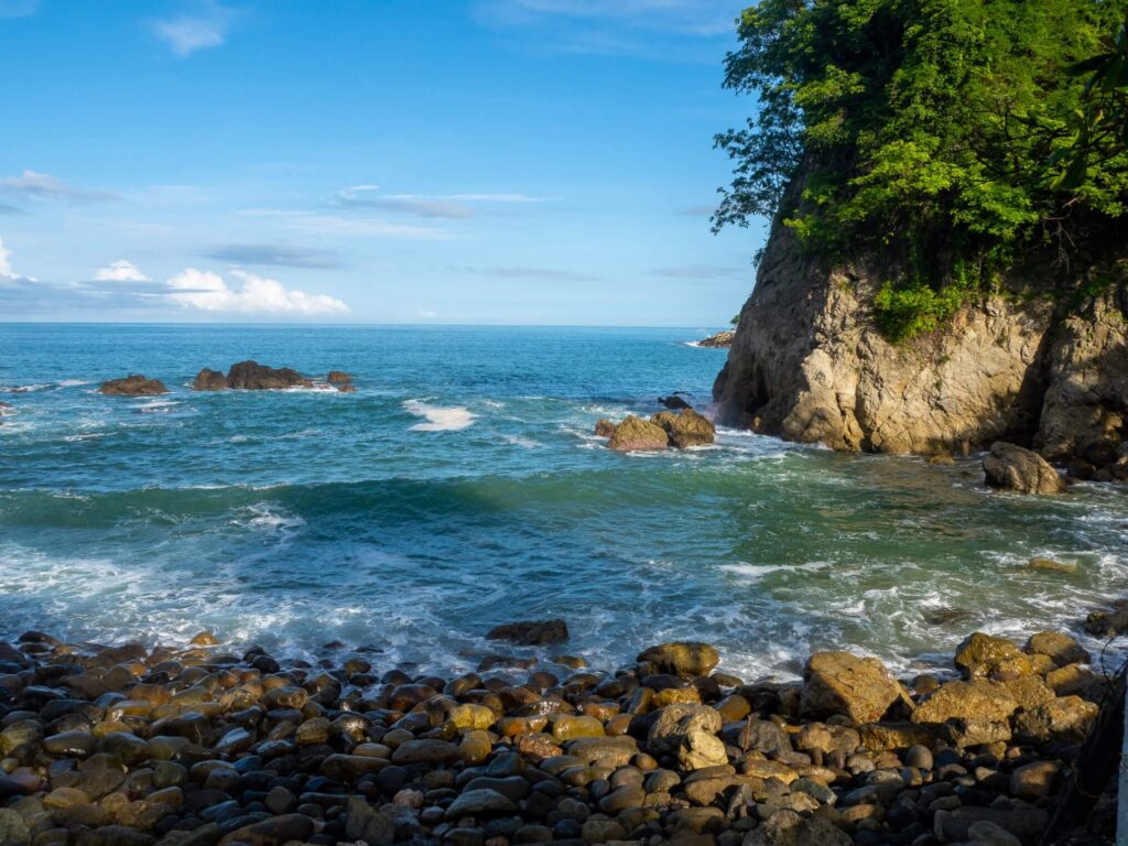 Small waves crashing on a rocky beach.
