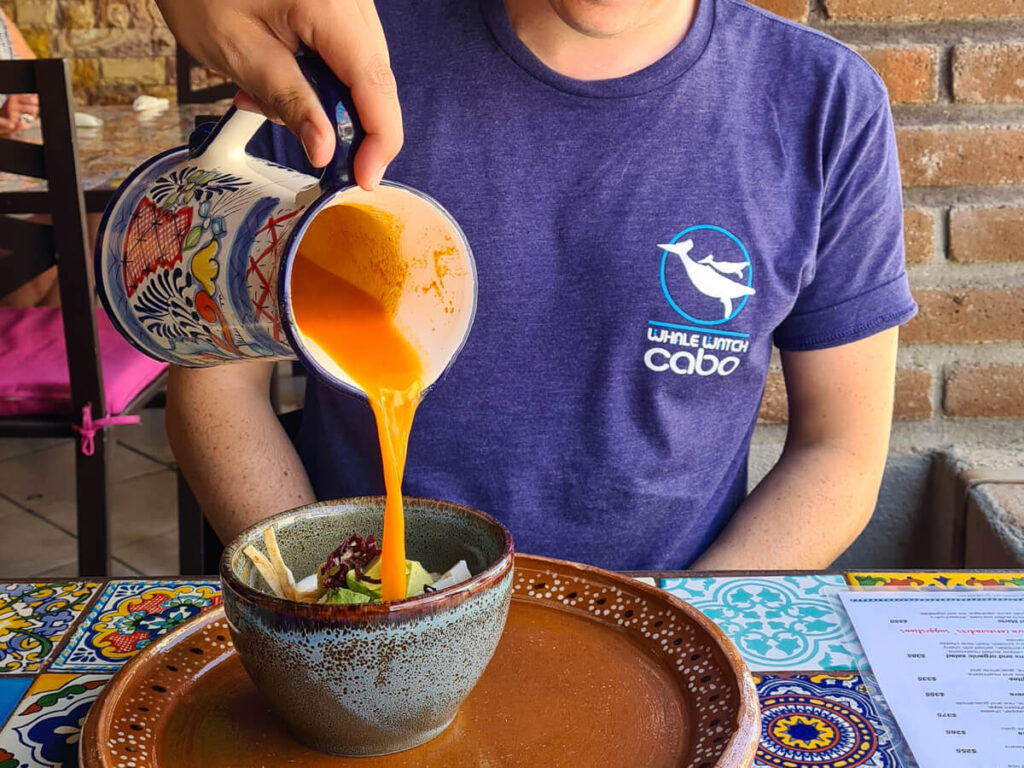A waiter pouring traditional Aztec Soup at a table in Jazmin's restaurant, San José del Cabo.