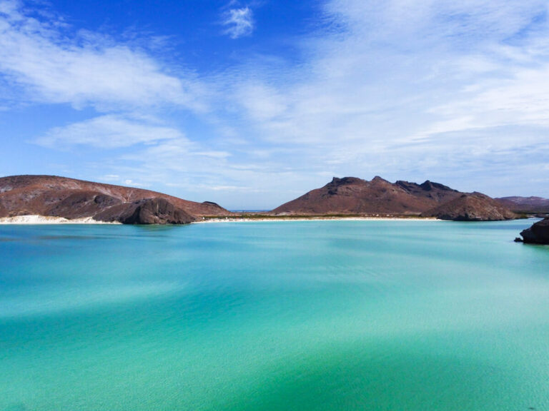 The white sands of Balandra Beach as viewed from a drone. A light breeze is moving across the otherwise calm water.