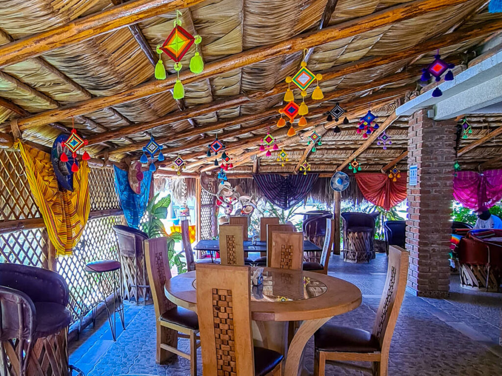 The restaurant at Hotel Isabela, San Carlos. The roof is a traditional Mexican palapa style of thatched palm and there are many colourful decorations hanging from it.