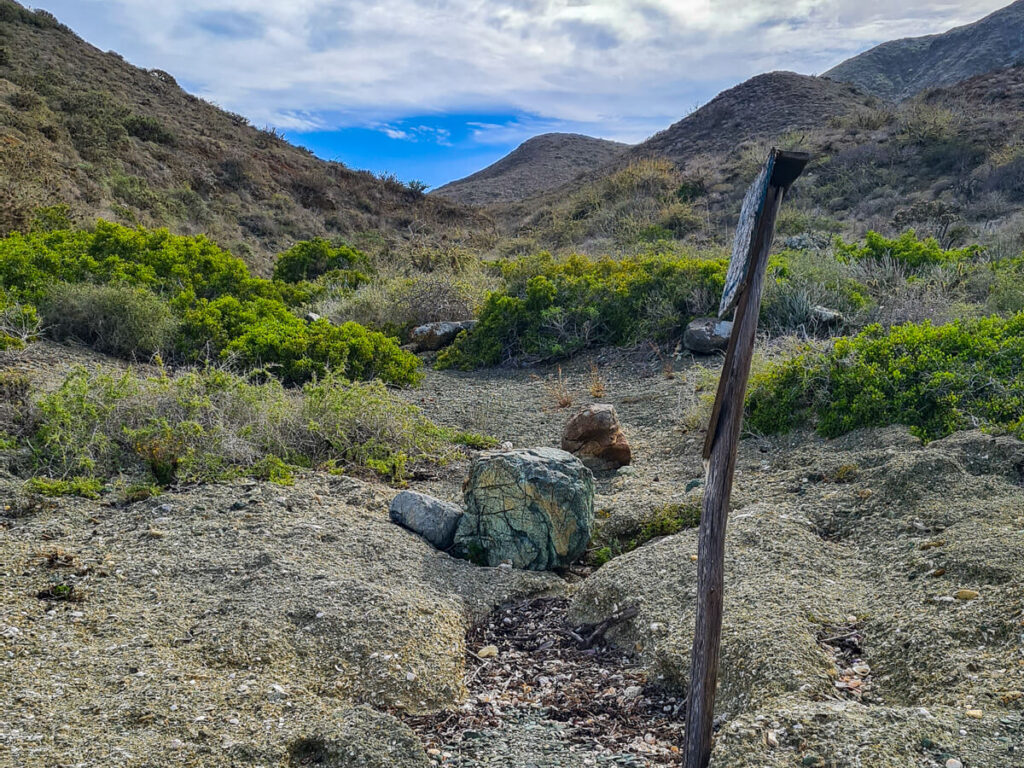The start of a hiking trail on Isla Magdalena. The path leads through the hills to the Pacific Ocean on the other side.