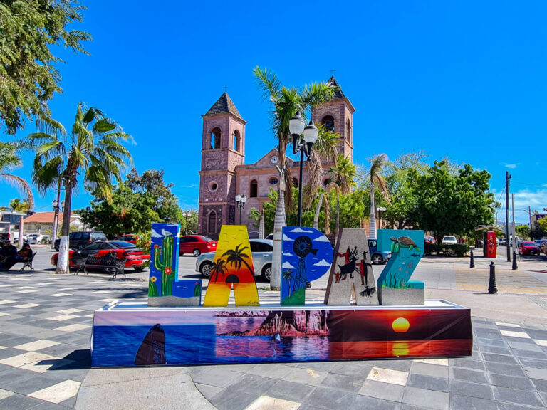 The painted La Paz sign in the centre of town sits in front of Nuestra Señora de la Paz Cathedra. Each letter of the sign has a different image painted on it, representing different elements of La Paz.