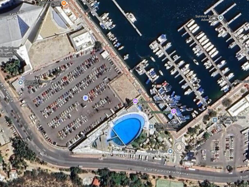 An aerial image of Cabo Adventures showing a small pool with dolphins in it and a large car park by the marina.
