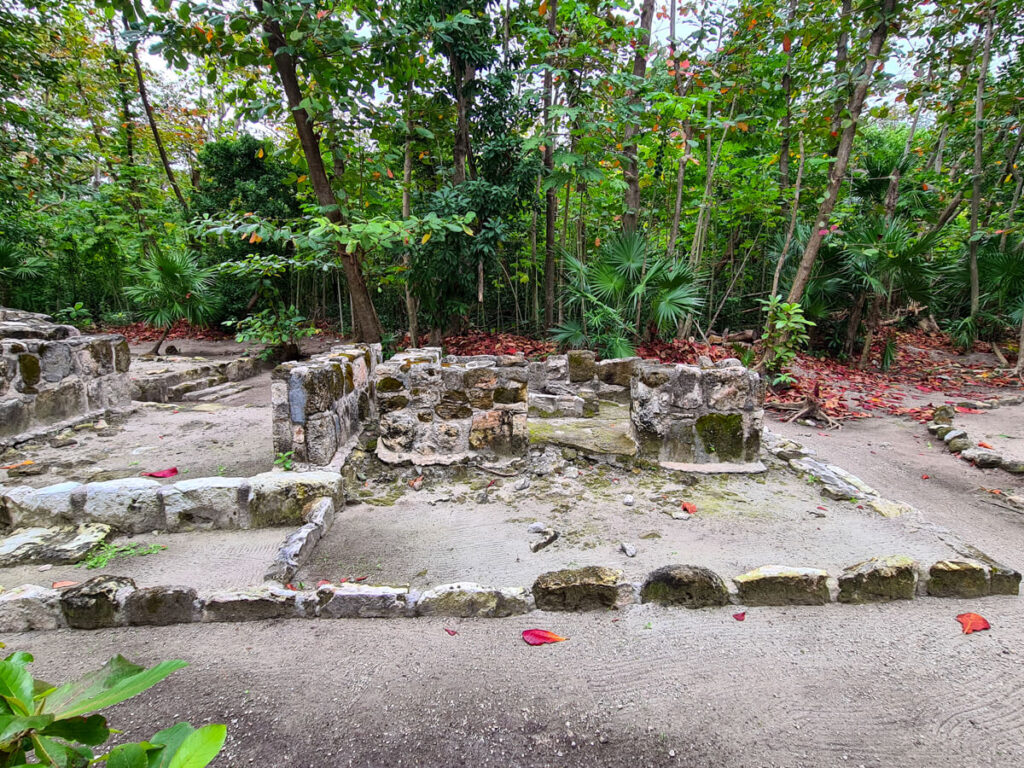 The stone outlines of several conjoined buildings outside at the Mayan Museum in Cancun.