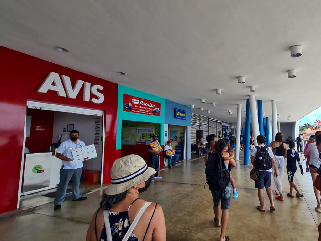 Car rental companies like Avis and Alamo at the Cozumel Ferry Dock.
