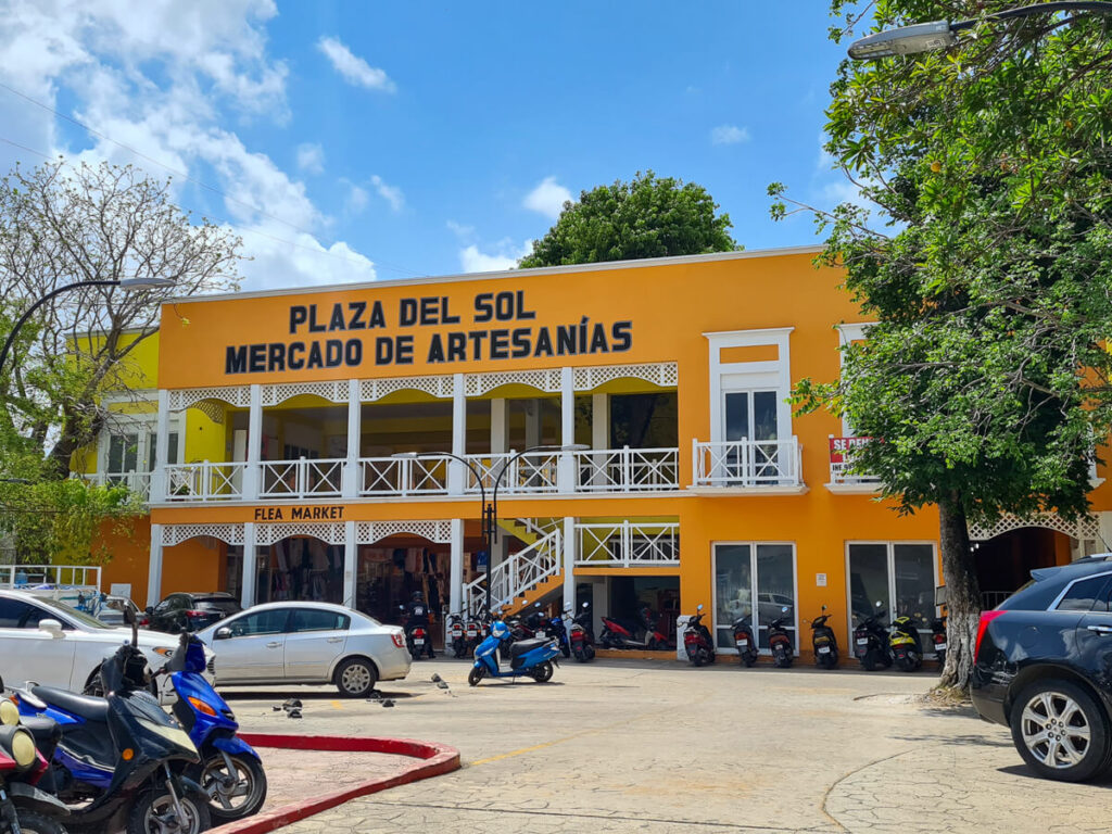 The bright orange exterior of the Plaza del Sol, an artisans' market in Cozumel.