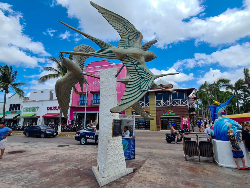 A statue of swallows on the malecón at the Cozumel Ferry dock.