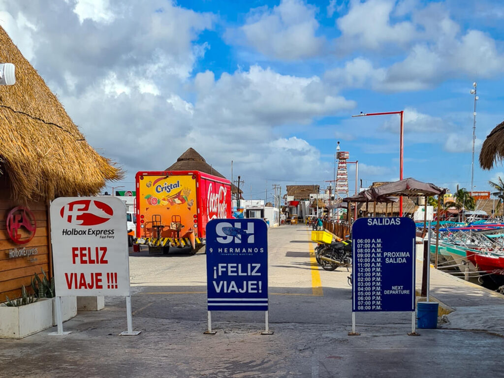 Sandwich boards with Holbox Ferry timetables at the dock in Chiquila.