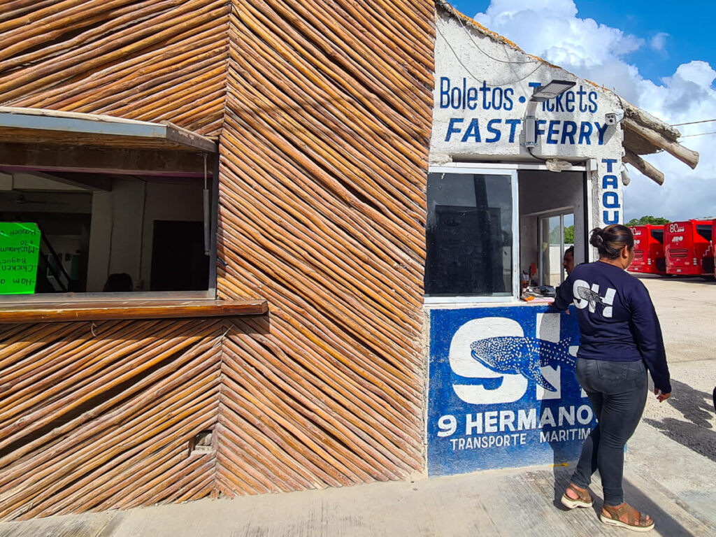 A woman at the ticket booth for the Holbox Ferry at the ADO bus terminal in Chiquila.