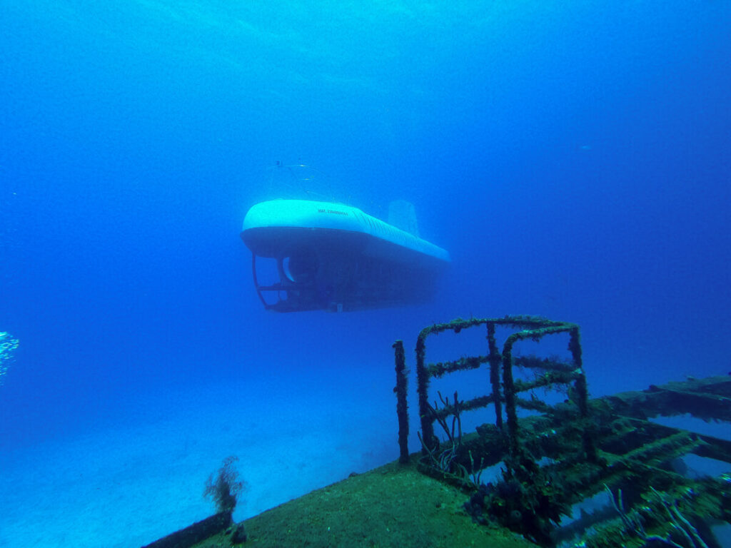 The Atlantis Submarine underwater sailing past a shipwreck dive site in Cozumel.