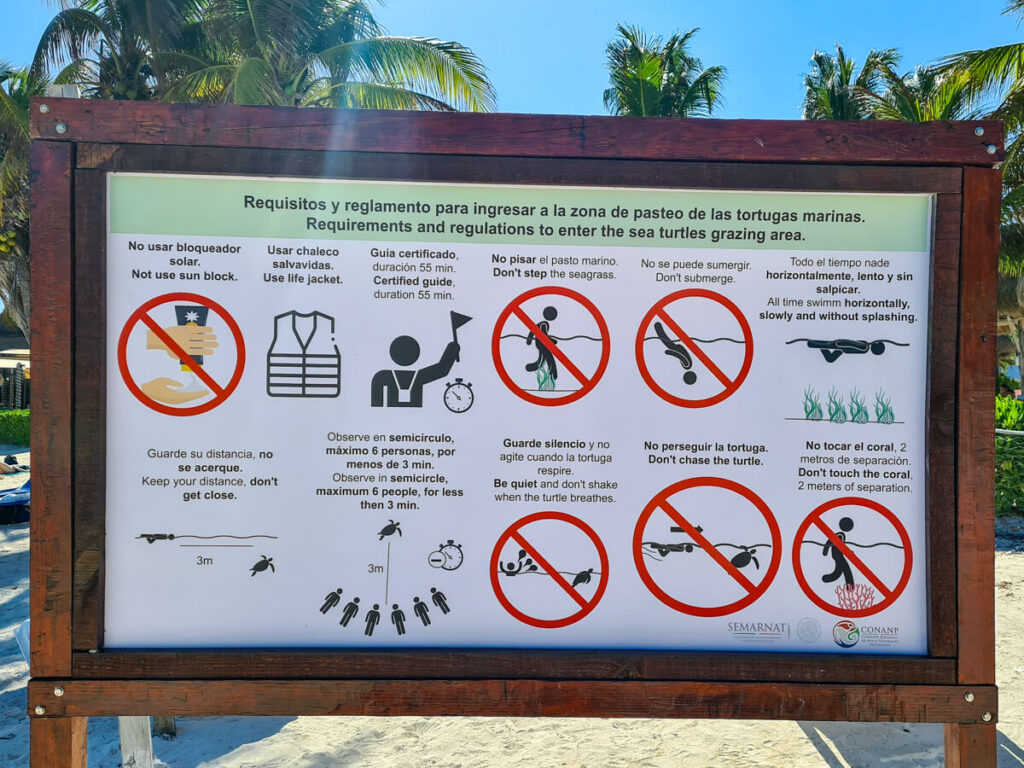 A sign depicting some of the rules and regulations of Akumal Bay, set by SEMARNAT.