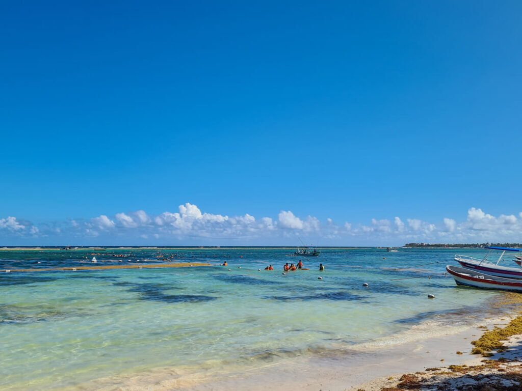 People in life jackets spread over the guided swimming zone in Akumal Bay.
