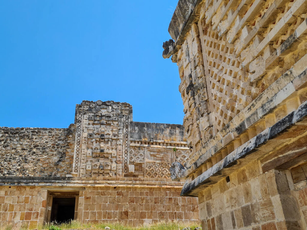 Detailed carved stone facades at a Mayan archaeological site.