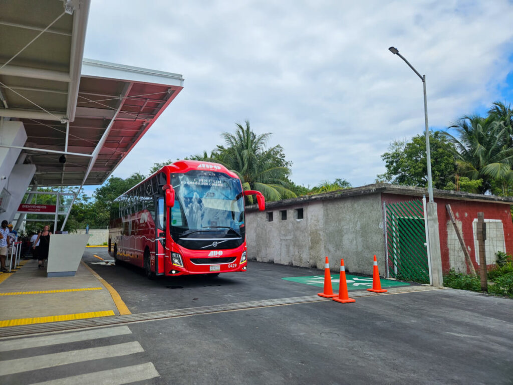 An ADO bus parked at a bus terminal in Mexico.