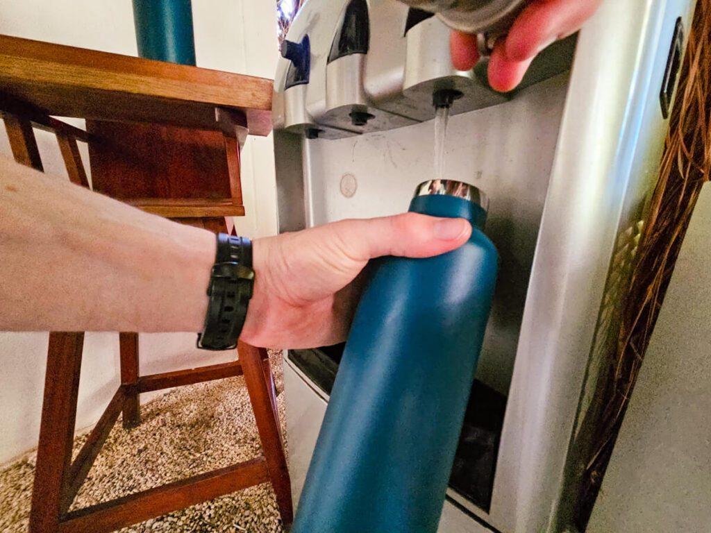 Dan filling up his bottle from a water cooler in the Casa Lamat restaurant.