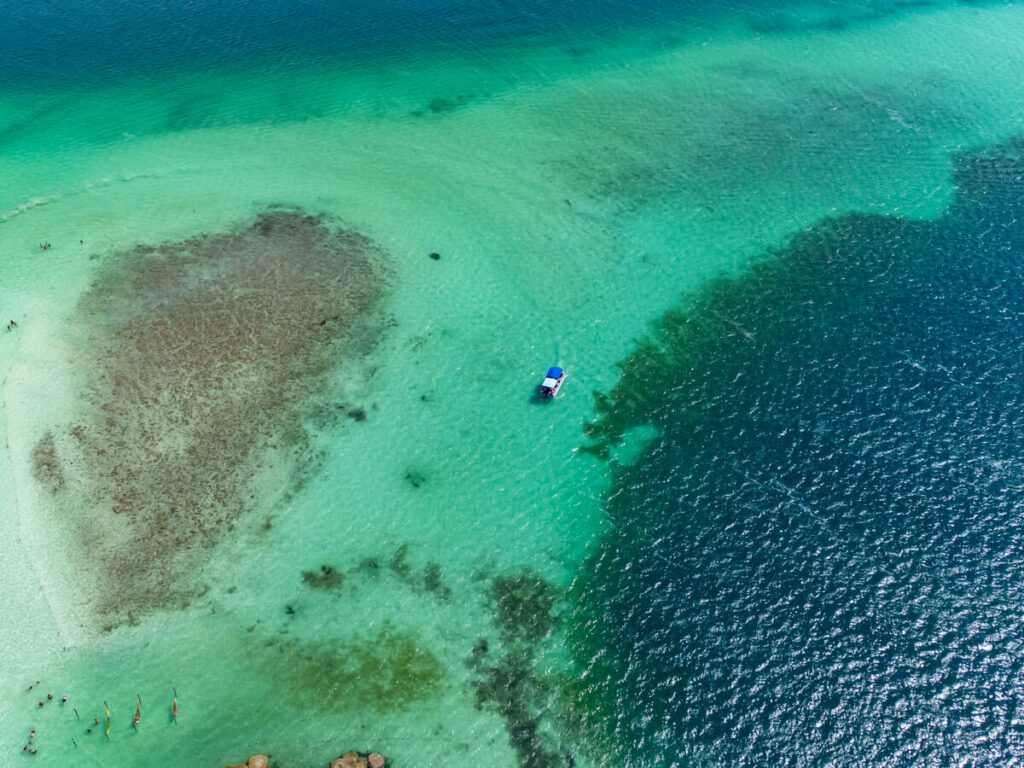 A small boat in the shallows of Bacalar Lagoon on the edge of the much deeper Cenote Cocalitos.