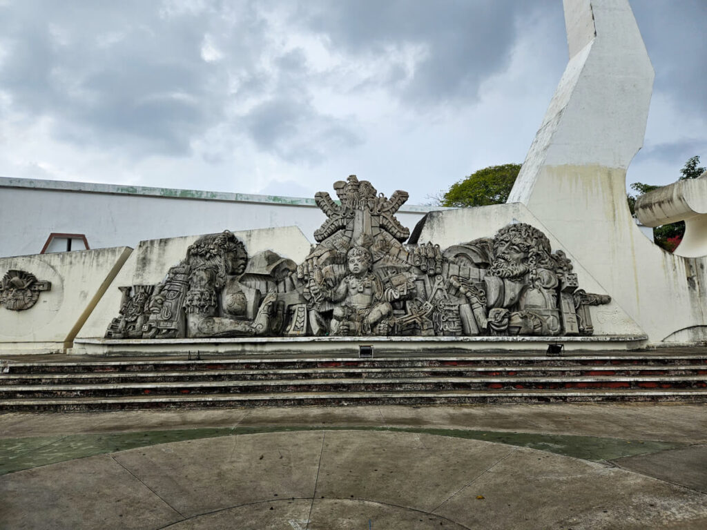 A large monument depicting Mayan people in Chetumal, Mexico.