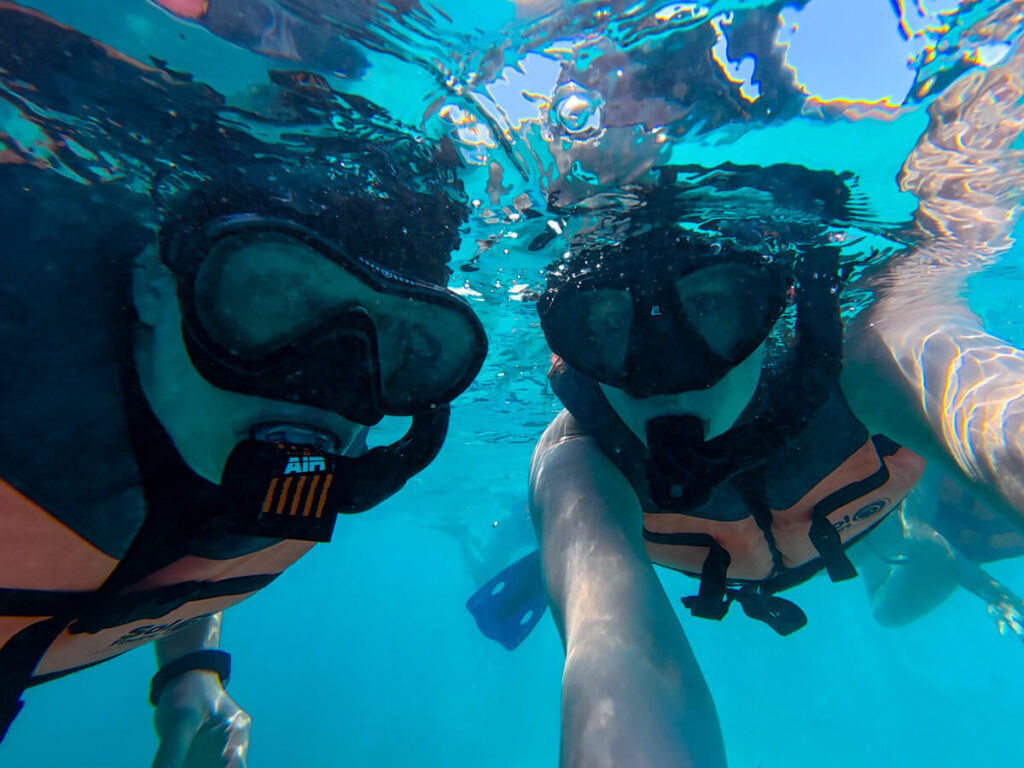 Dan and Lucy face the camera in their snorkel gear on an Isla Contoy snorkelling tour.