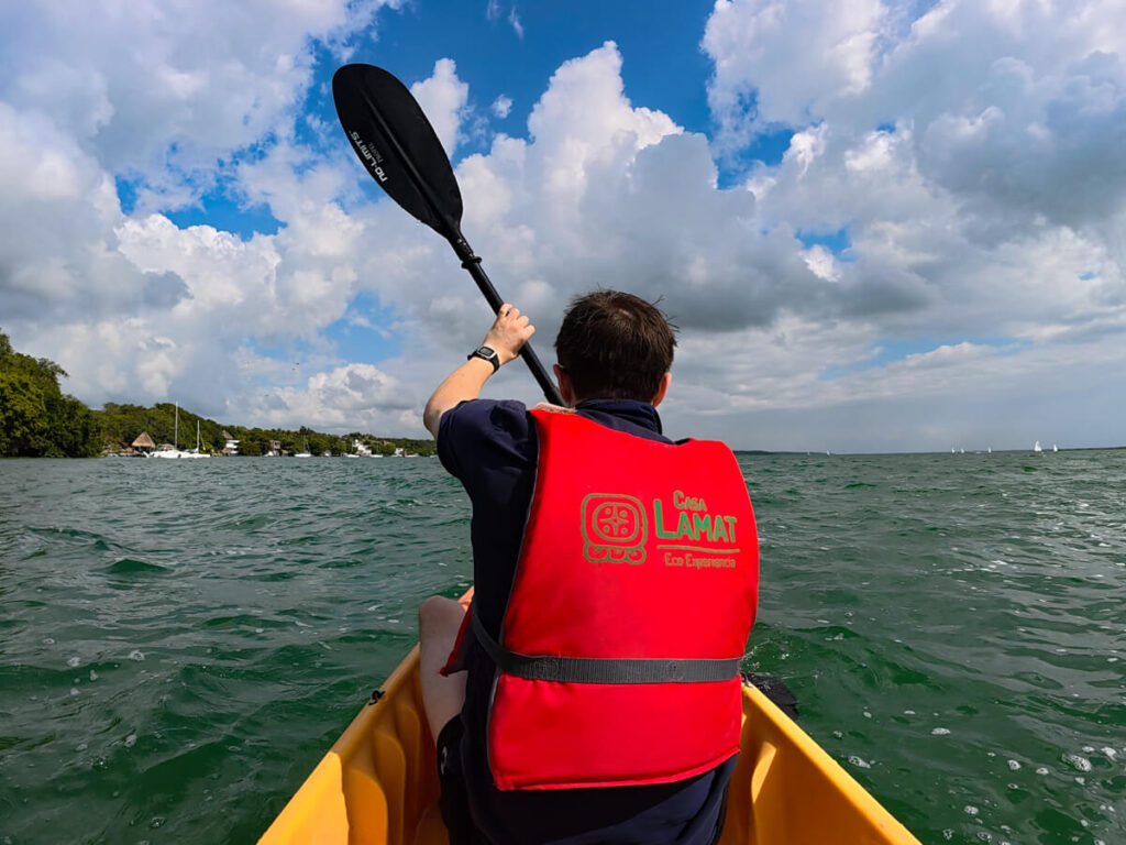 Dan kayaking in Bacalar Lagoon. The back of his Life Vest reads "Casa Lamat Eco Experiencia".