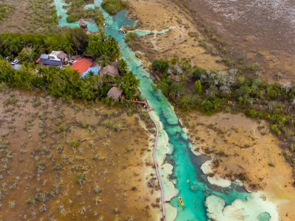 Los Rapidos, a natural lazy river of clear blue water cutting through ancient rock, in Bacalar.