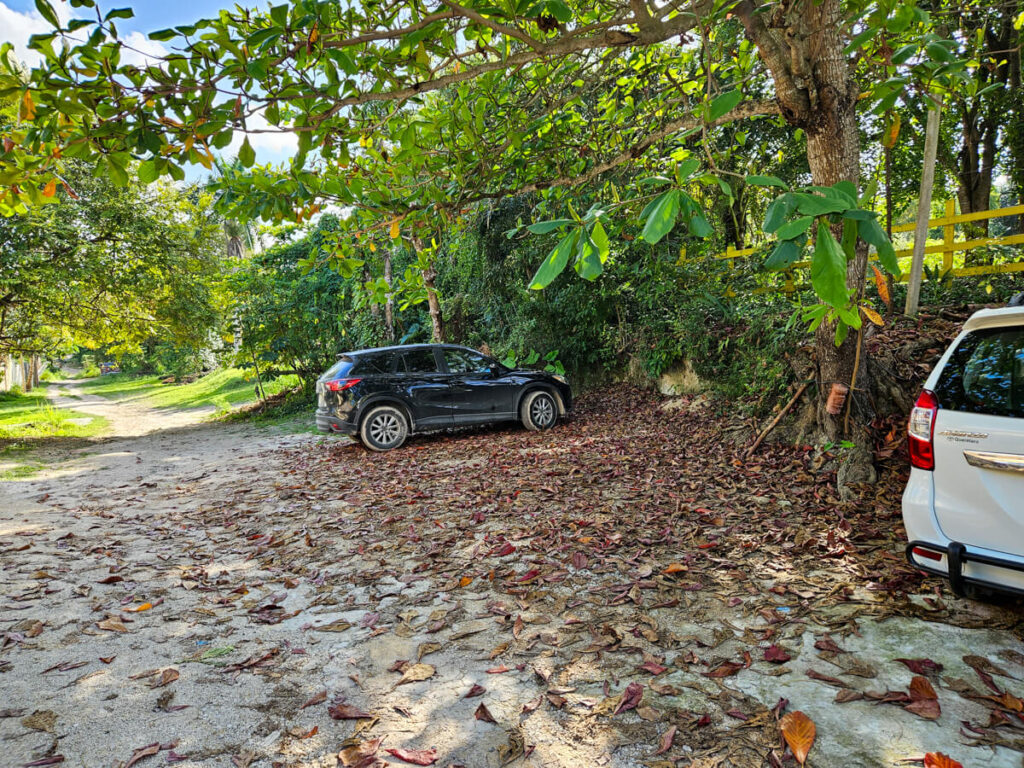 Car parking at the Eco-hotel Casa Lamat. The parking is outside under the cover of trees.