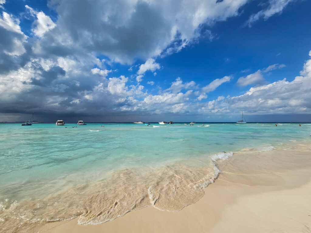 Boats and tourists in the shallows of Playa Norte, Isla Mujeres.