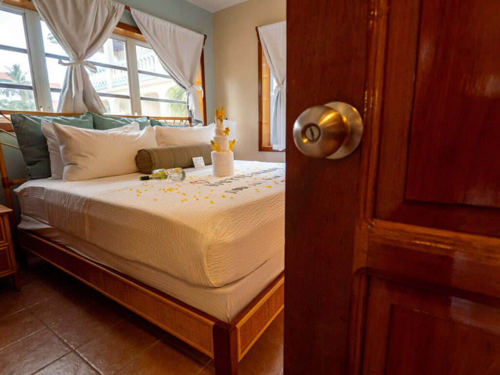 Taking a peek inside a welcoming bedroom in a suite at Belizean Shores Resort, San Pedro. A birthday message and a bottle of wine have been left on the bed for two lucky guests.