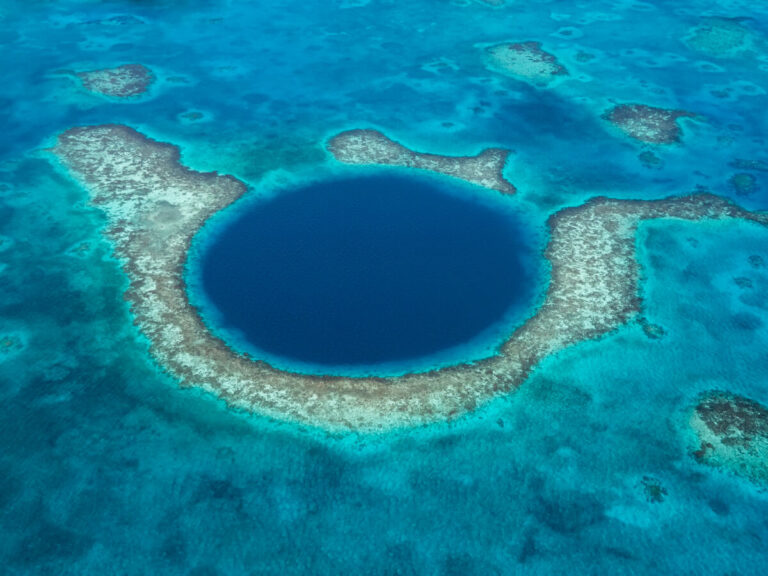 An aerial view of the Great Blue Hole, a sinkhole in the middle of the Belize Barrier Reef.