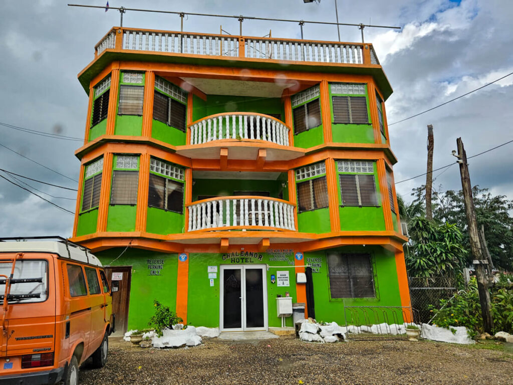 The orange and green facade of the Chaleanor Hotel in Dangriga.