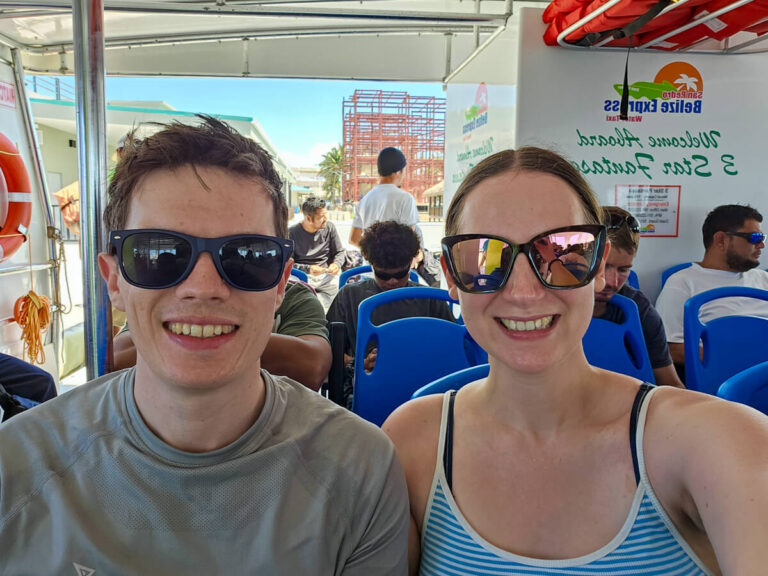 Dan and Lucy smiling in their sunglasses as they prepare to leave Ambergris Caye on the San Pedro Belize Express Ferry.