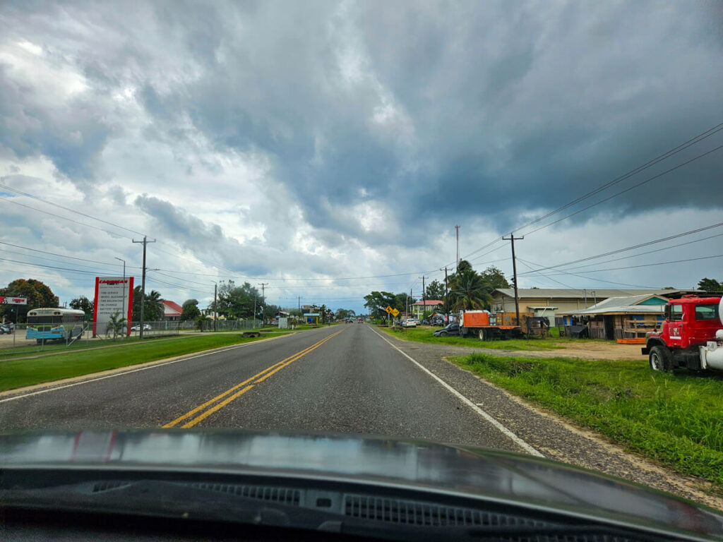 The main road through Dangriga, taken through the windshield of a car.