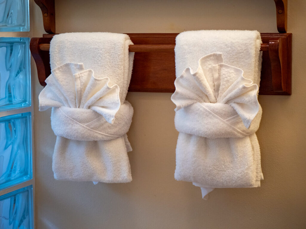 Face towels have been folded into fan shapes in a bathroom at Belizean Shores Resort.